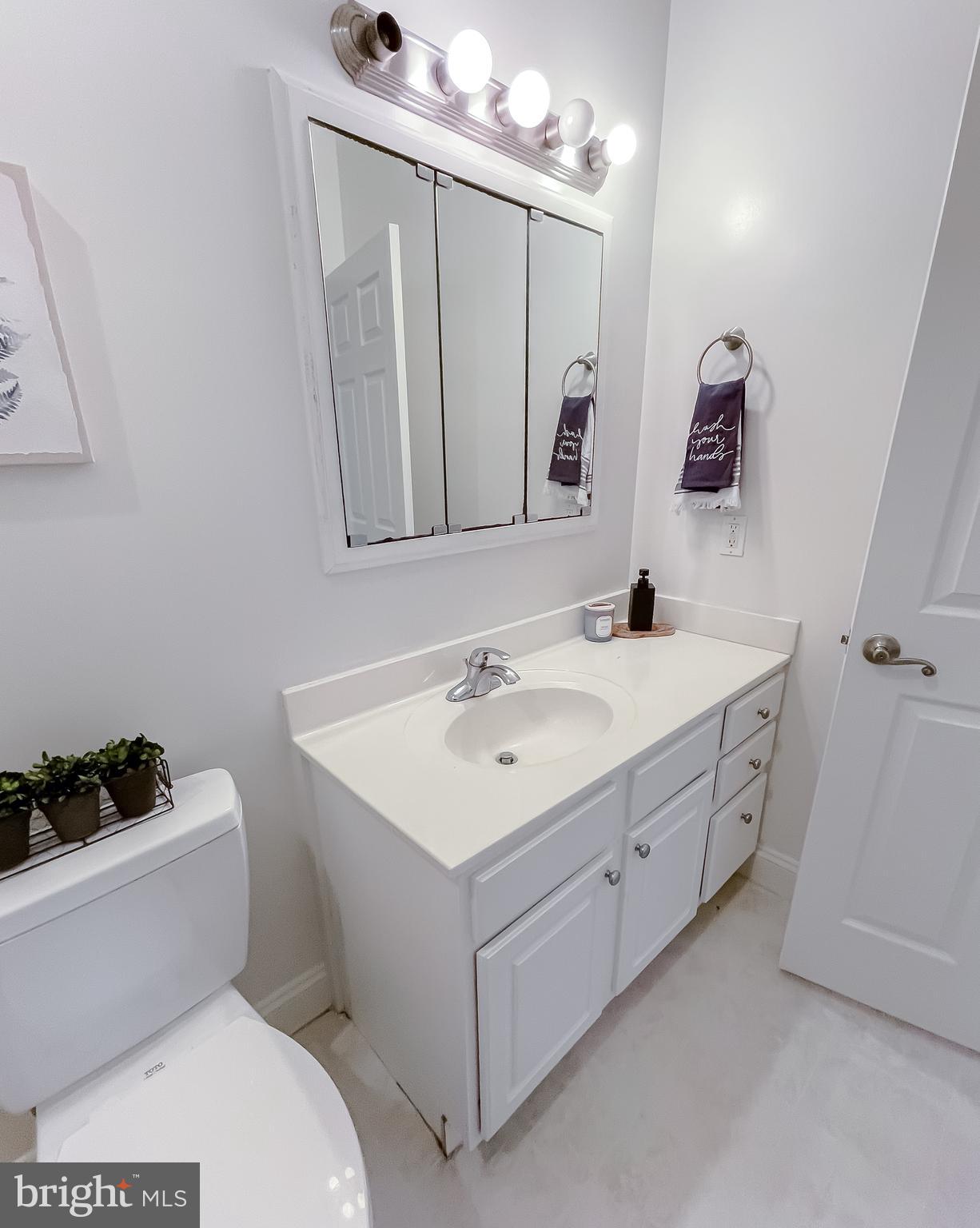 48673 Trapp Road St. Inigoes, MD 20684 - Photo 20 of 39 a bathroom with a sink toilet and mirror