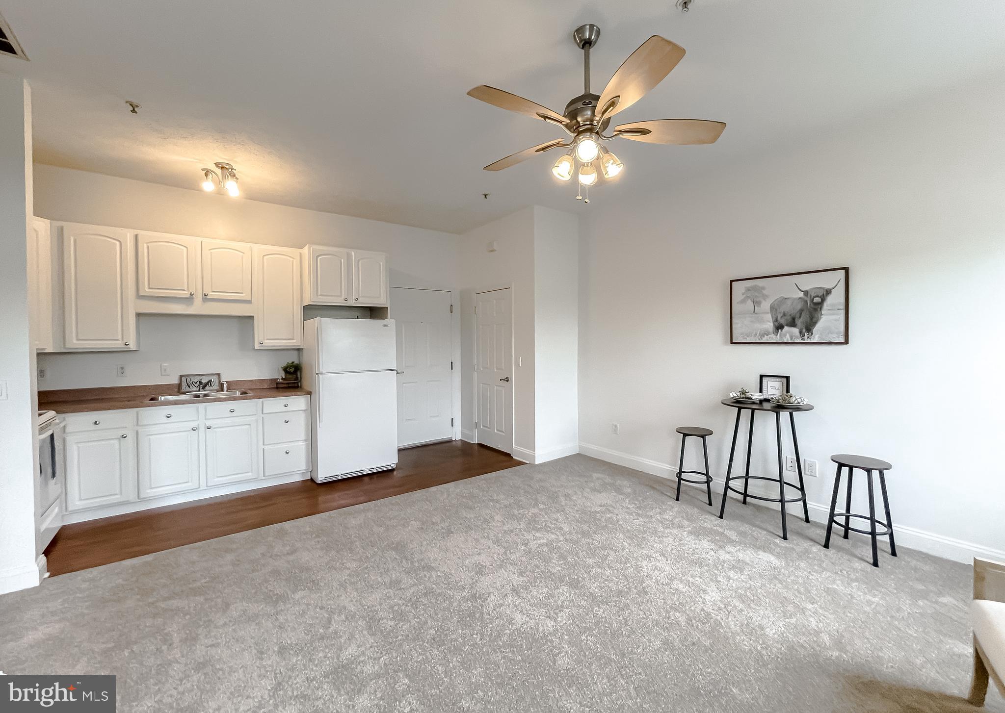 48673 Trapp Road St. Inigoes, MD 20684 - Photo 7 of 39 a kitchen with a refrigerator and white cabinets