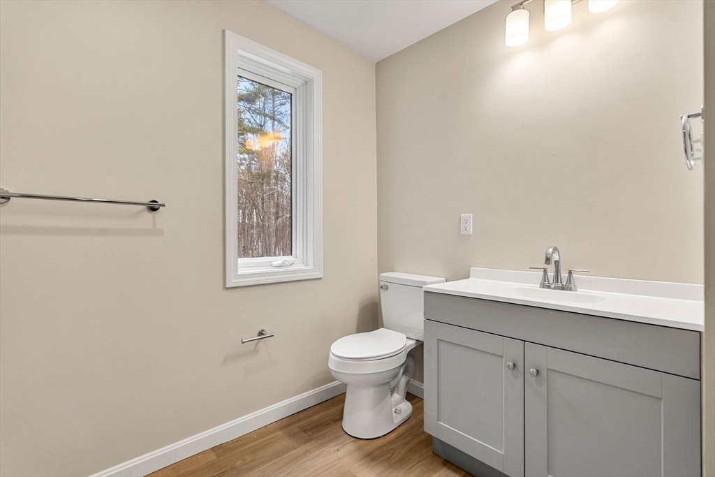 153 Coffin Road, Unit 10 Epping, NH 03042 - Photo 12 of 31 a bathroom with a toilet a sink and mirror