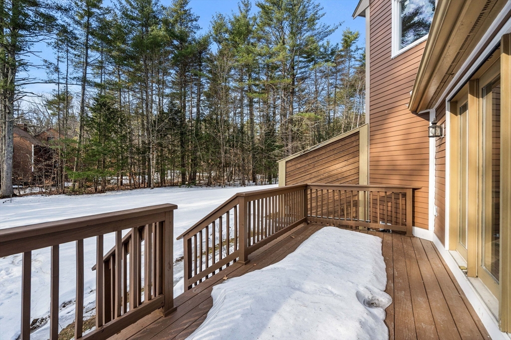153 Coffin Road, Unit 10 Epping, NH 03042 - Photo 24 of 31 a balcony with view of trees in the background
