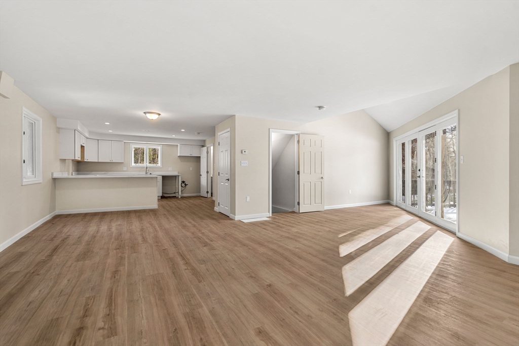 153 Coffin Road, Unit 10 Epping, NH 03042 - Photo 26 of 31 a view of a kitchen with wooden floor and a kitchen