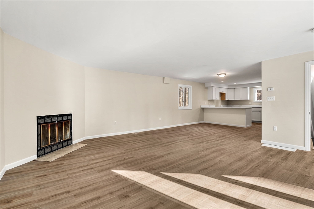 153 Coffin Road, Unit 10 Epping, NH 03042 - Photo 27 of 31 a view of kitchen and hall with wooden floor