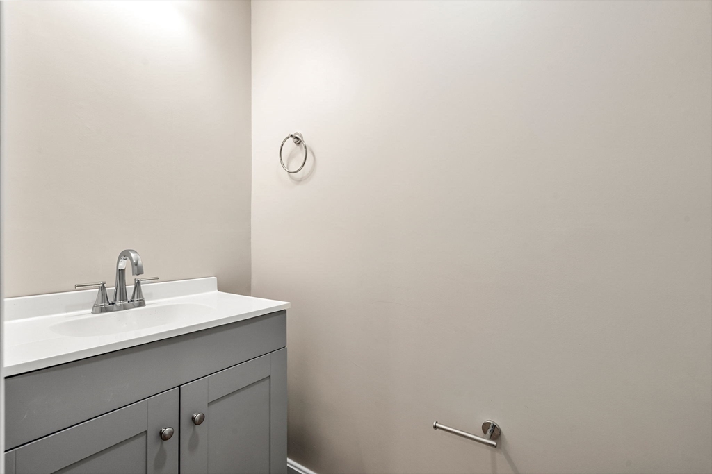 153 Coffin Road, Unit 10 Epping, NH 03042 - Photo 7 of 31 a bathroom with a sink and a mirror