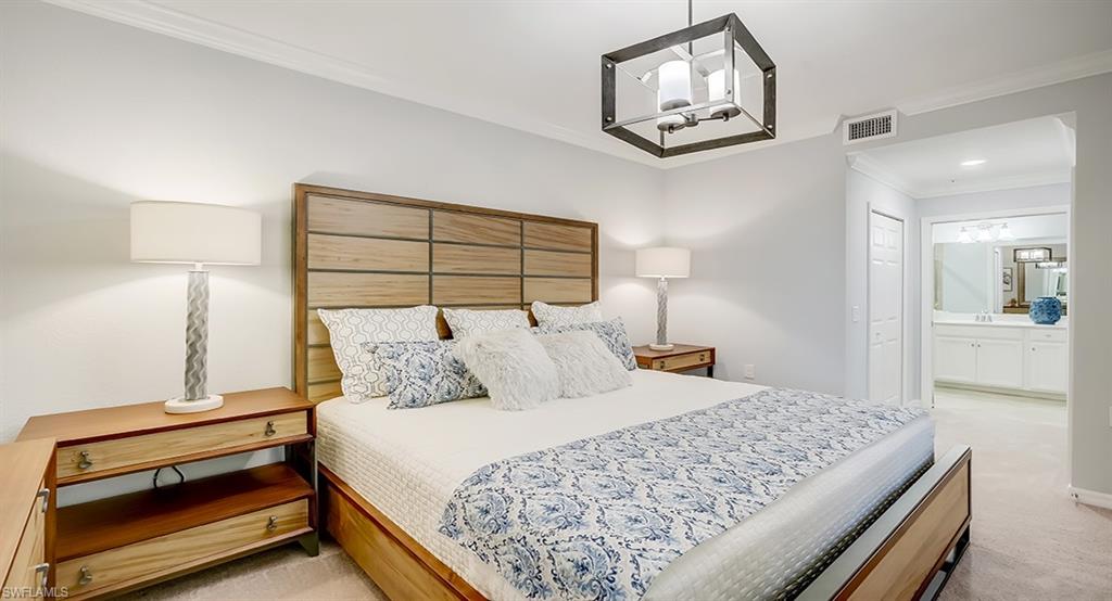 9584 Trevi Court, Unit 5227 Naples, FL 34113 - Photo 13 of 26 a bedroom with a bed and painting on the wall