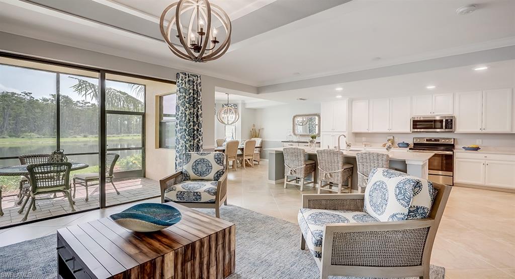 9584 Trevi Court, Unit 5227 Naples, FL 34113 - Photo 3 of 26 a living room with fireplace furniture and a large window