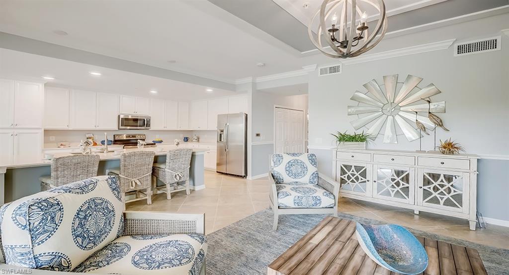 9584 Trevi Court, Unit 5227 Naples, FL 34113 - Photo 4 of 26 a living room with furniture and kitchen view