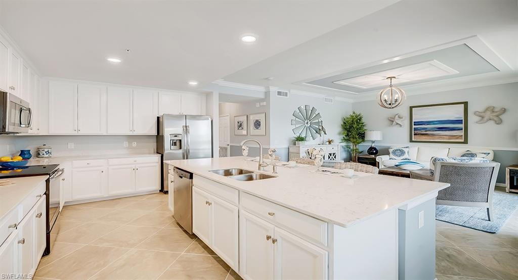 9584 Trevi Court, Unit 5227 Naples, FL 34113 - Photo 7 of 26 a kitchen with a sink stove and cabinets