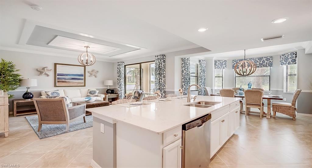 9584 Trevi Court, Unit 5227 Naples, FL 34113 - Photo 8 of 26 a living room with stainless steel appliances a table and chairs