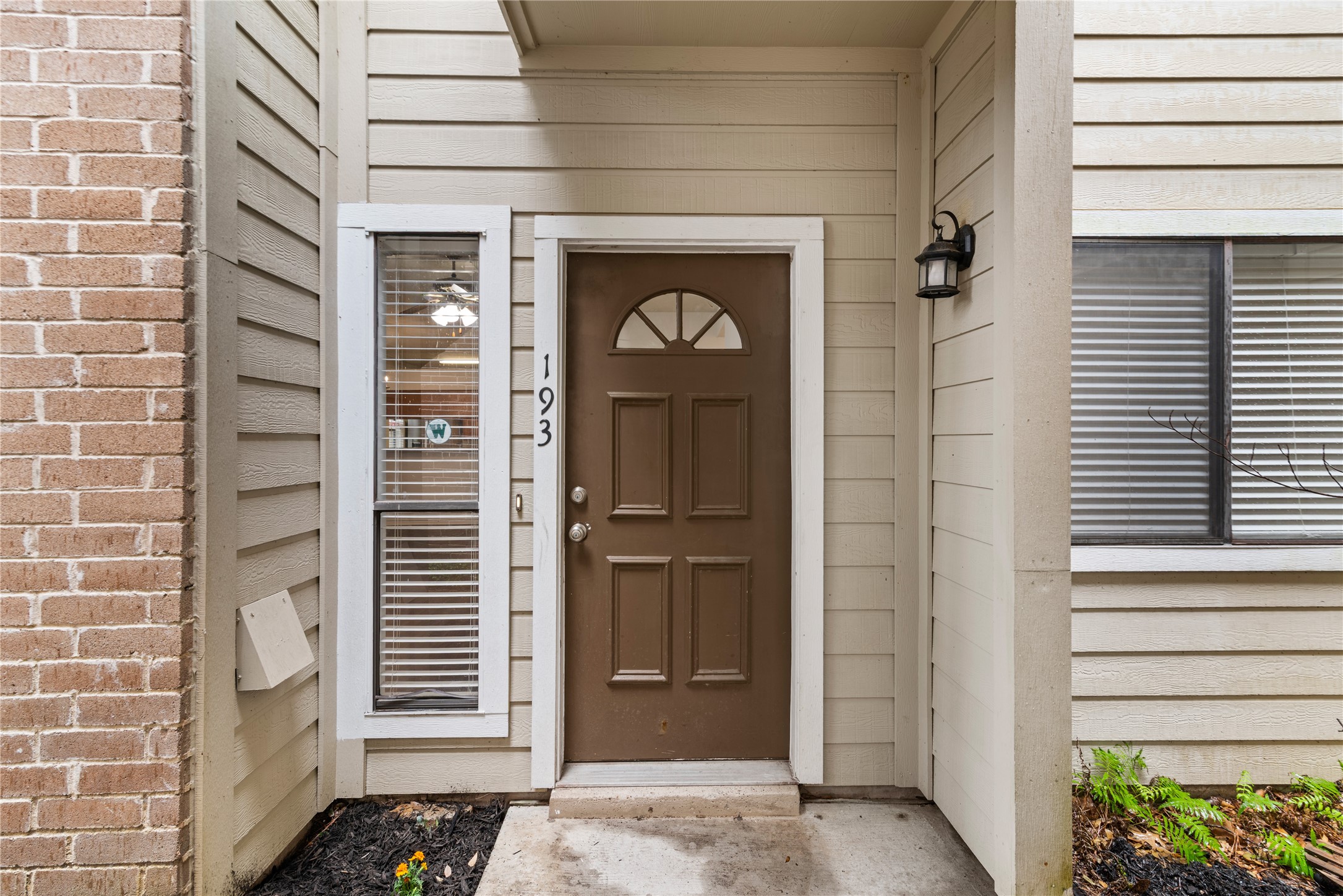 #193-is move in ready, seller offering benefits to buyer. Easy ground floor access with a brown door, with a vertical window for extra exterior light and security.