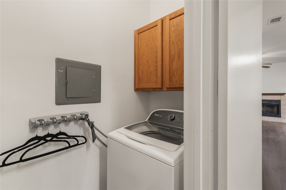3500 Tangle Brush Drive, Unit 193 Spring, TX 77381 - Photo 11 of 26 Convenient Laundry area complete with full size Washer and Dryer! Top-loading washer, wooden overhead cabinets, and hanger hooks. It’s adjacent to the living space, which features a fireplace.
