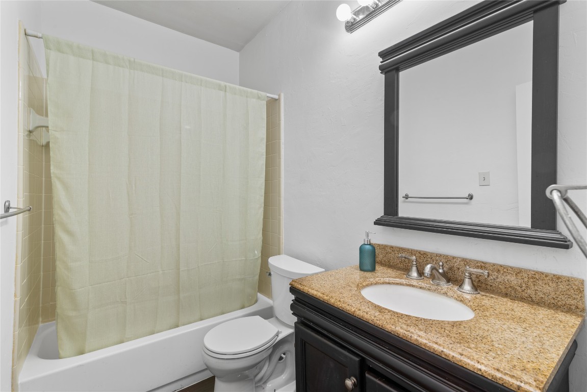 3500 Tangle Brush Drive, Unit 193 Spring, TX 77381 - Photo 16 of 26 This bathroom features a classic design with a shower-tub combo, a granite countertop, and a dark-framed mirror. It offers practical fixtures and a neutral color palette, providing a clean and functional space.