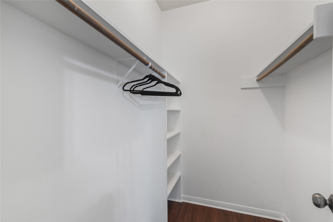 3500 Tangle Brush Drive, Unit 193 Spring, TX 77381 - Photo 20 of 26 Spacious walk-in closet with white walls, wooden flooring, and multiple shelves and hanging rods for ample storage.