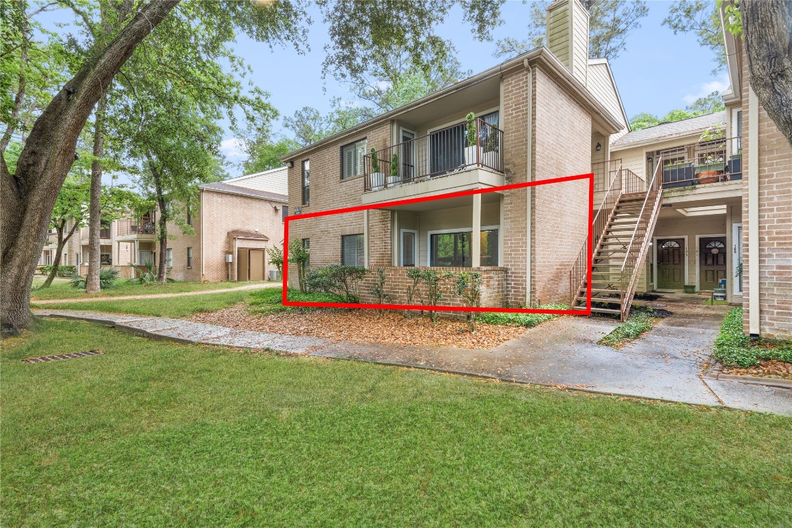 3500 Tangle Brush Drive, Unit 193 Spring, TX 77381 - Photo 21 of 26 Ground floor location with a brick exterior and covered patio. It's surrounded by green lawns and large trees, offering a peaceful environment. The area entrance is well-maintained.