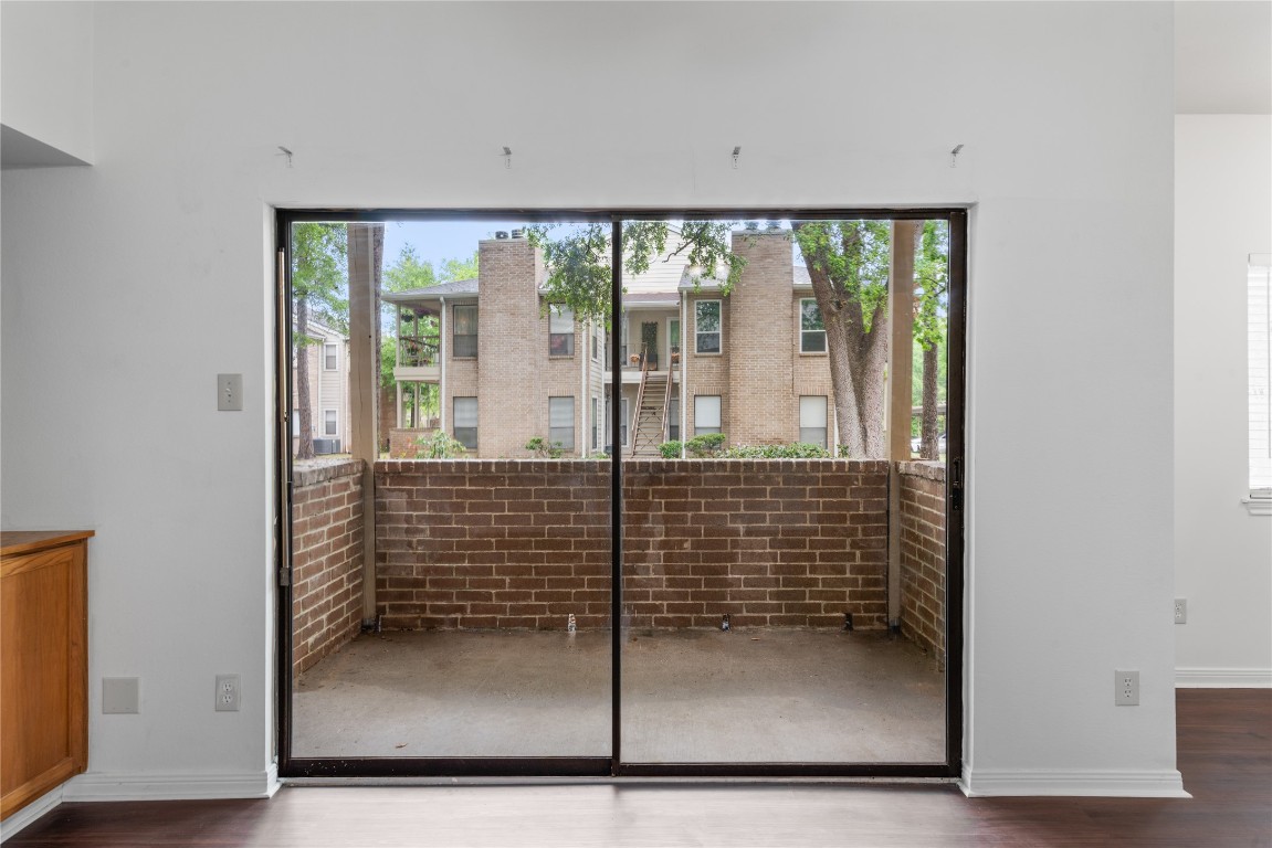 3500 Tangle Brush Drive, Unit 193 Spring, TX 77381 - Photo 23 of 26 Large sliding glass doors leading to your private brick balcony with accent trees. The interior features a clean and modern look.