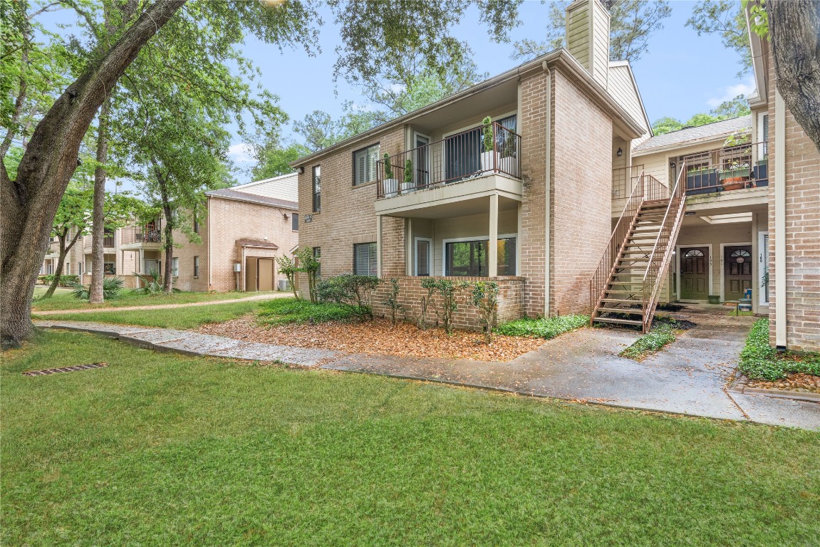 3500 Tangle Brush Drive, Unit 193 Spring, TX 77381 - Photo 24 of 26 Ground floor with Brick Private Porch. The property is surrounded by lush greenery and mature trees, offering a tranquil setting in a well-maintained community.