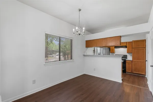a kitchen with stainless steel appliances granite countertop a sink and dishwasher cabinets with wooden floor