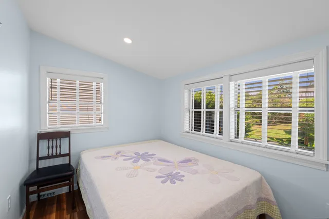 a bedroom with a bed and a large window