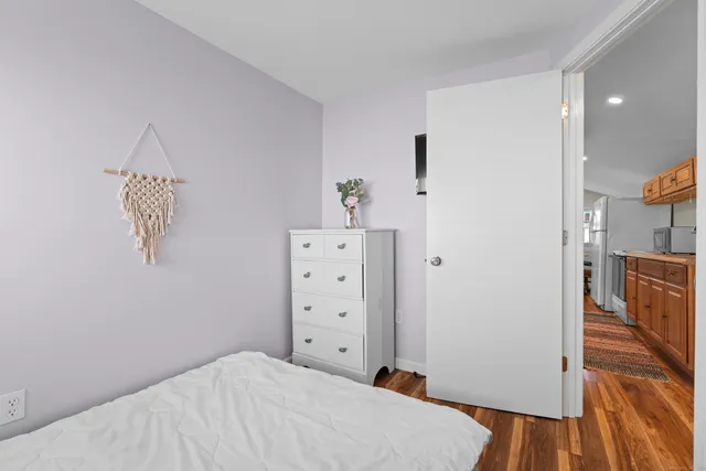 a bedroom with a bed and a view of kitchen