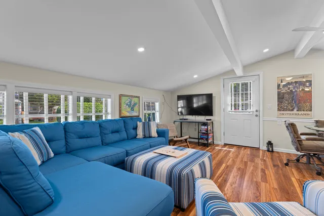 a bedroom with furniture and a flat screen tv