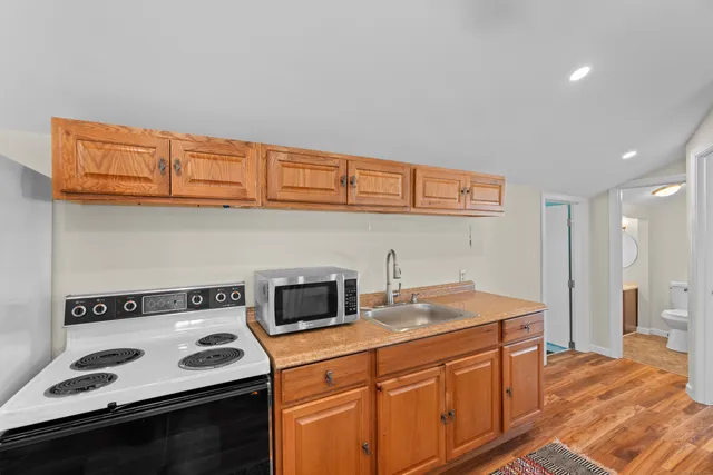 a kitchen with stainless steel appliances granite countertop a sink stove and cabinets