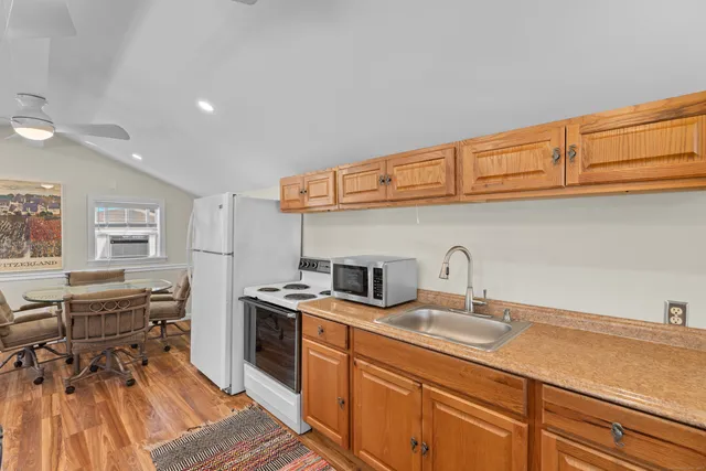 a kitchen with stainless steel appliances granite countertop a sink and cabinets