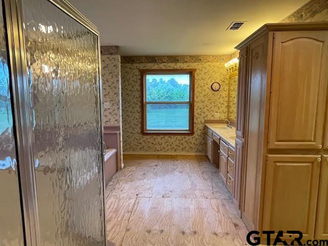 109 Cherry Blossom Road Ore City, TX 75683 - Photo 27 of 32 a view of a hallway with wooden floor and a living room