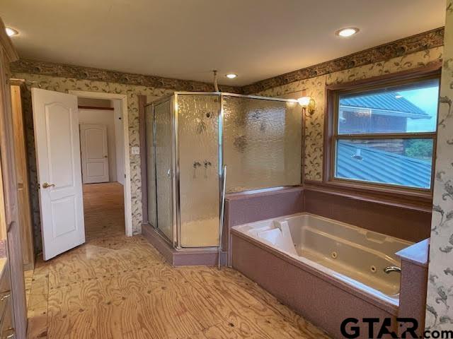 109 Cherry Blossom Road Ore City, TX 75683 - Photo 28 of 32 a bathroom with a bathtub and a shower