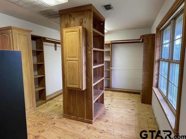 109 Cherry Blossom Road Ore City, TX 75683 - Photo 29 of 32 a view of walk in closet with empty racks