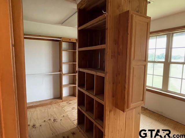 109 Cherry Blossom Road Ore City, TX 75683 - Photo 30 of 32 a view of walk in closet with empty racks