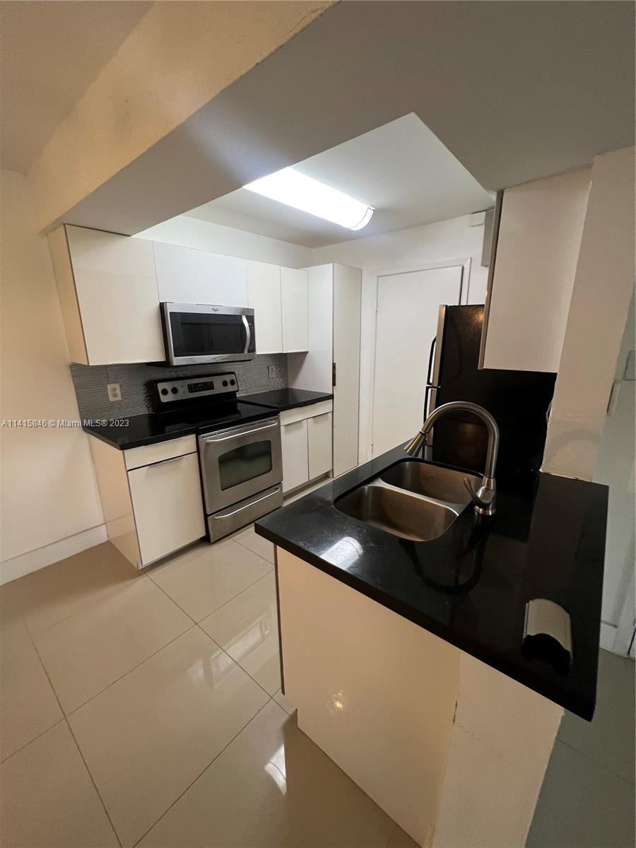 The Hammocks Miami, FL 33196 - Photo 8 of 20 a kitchen with a sink and a stove top oven