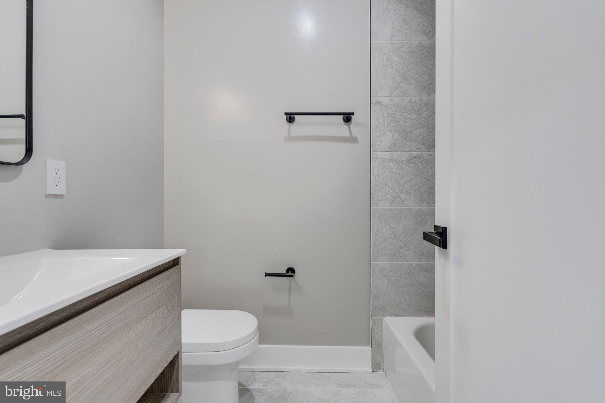 1703 West Virginia Avenue Northeast, Unit 2 Washington, DC 20002 - Photo 15 of 54 a white toilet sitting next to a bathroom sink