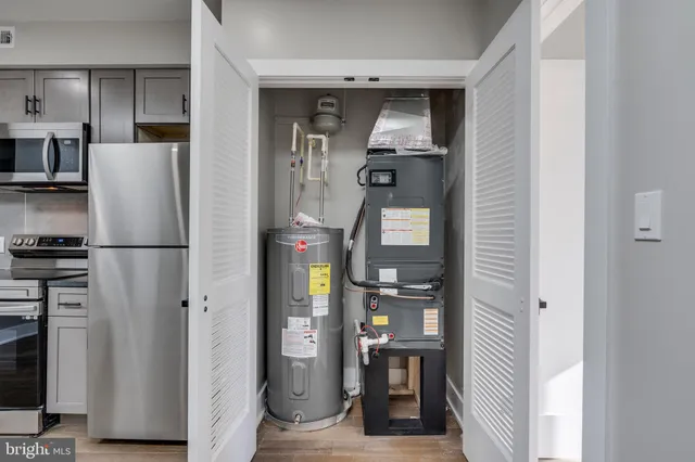 a view of kitchen view with refrigerator stove and cabinets
