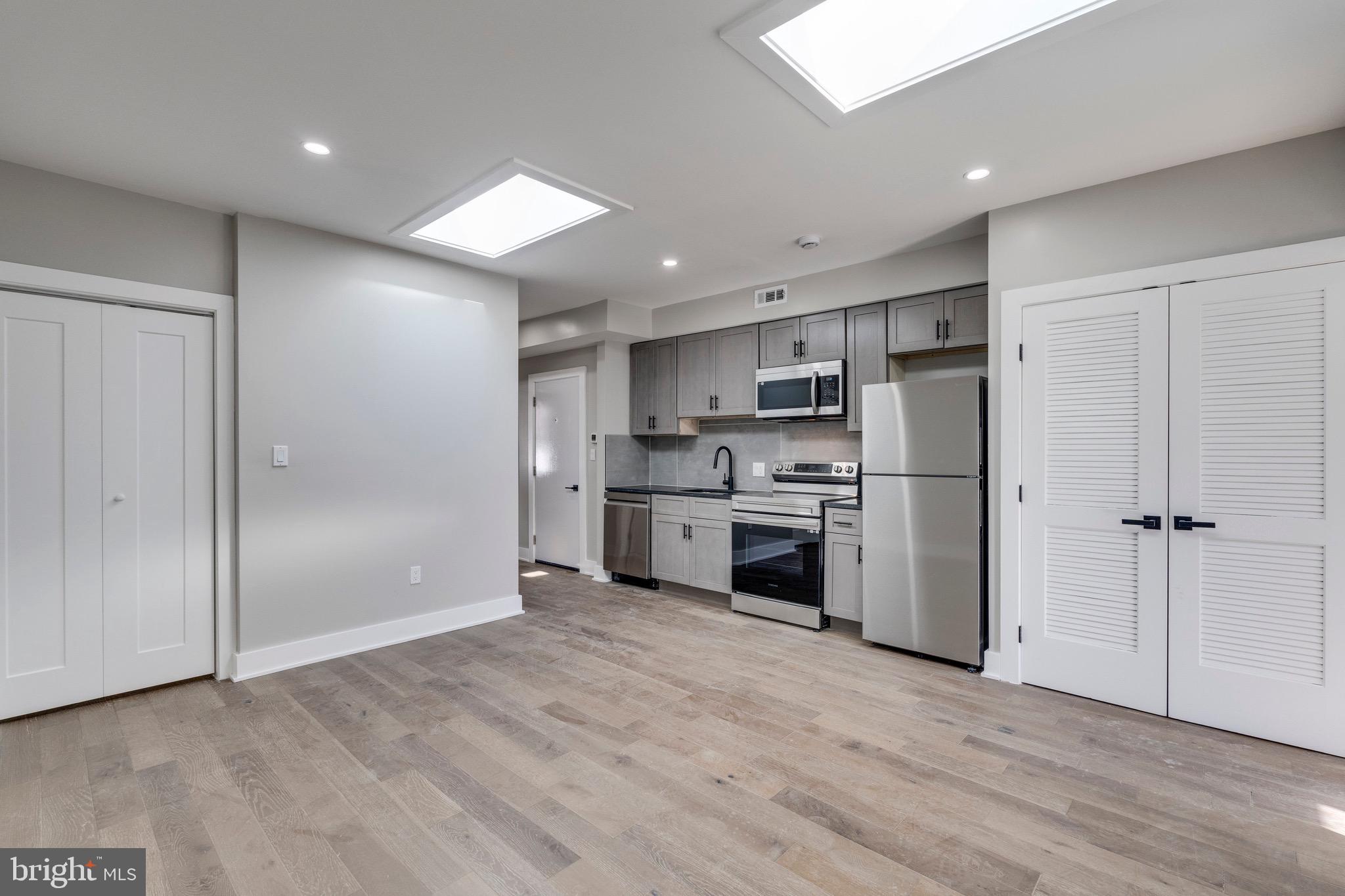 1703 West Virginia Avenue Northeast, Unit 2 Washington, DC 20002 - Photo 31 of 54 a kitchen with white cabinets and stainless steel appliances