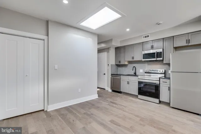 a kitchen with a refrigerator stove and microwave