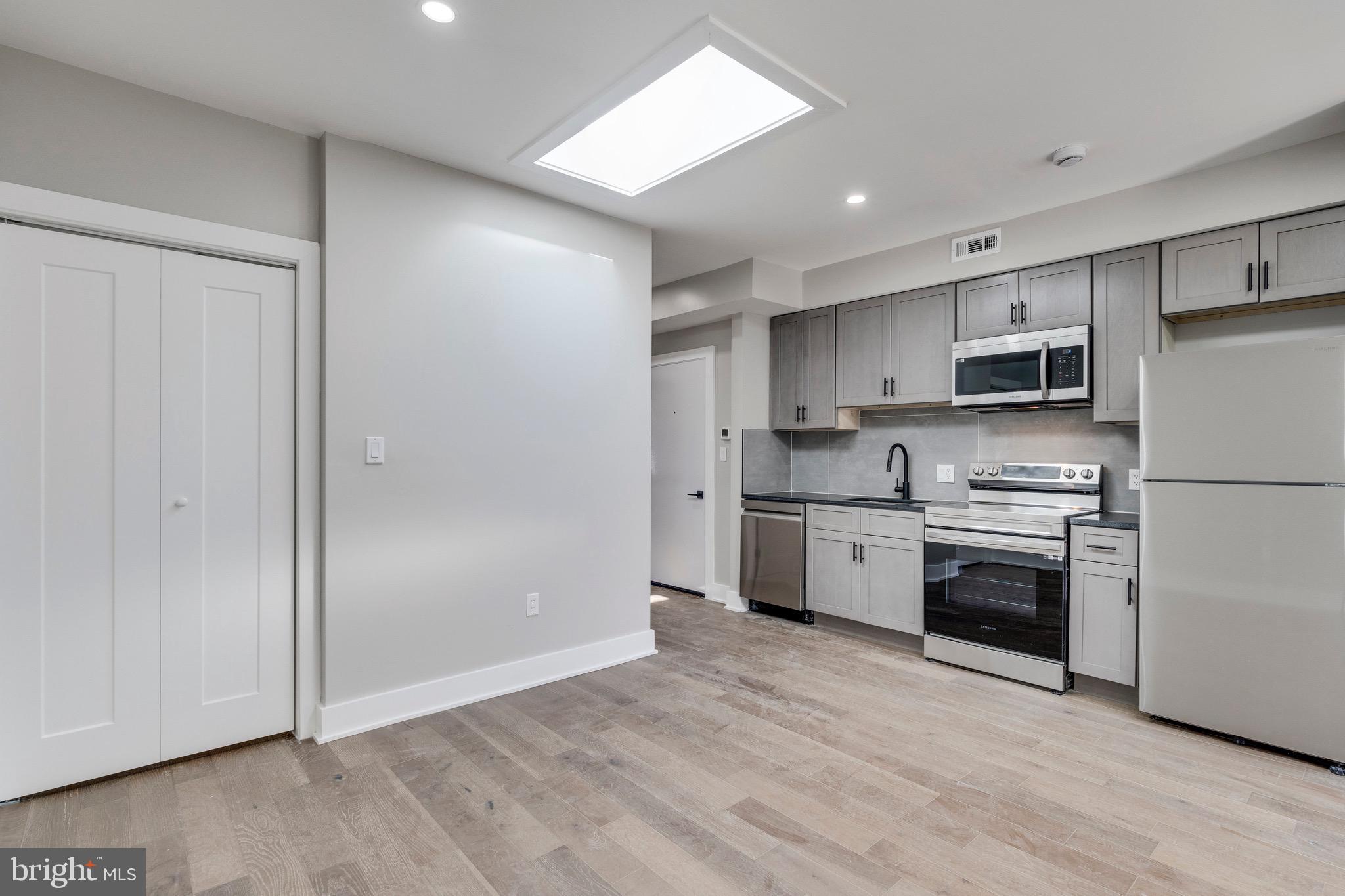 1703 West Virginia Avenue Northeast, Unit 2 Washington, DC 20002 - Photo 32 of 54 a kitchen with a refrigerator stove and microwave