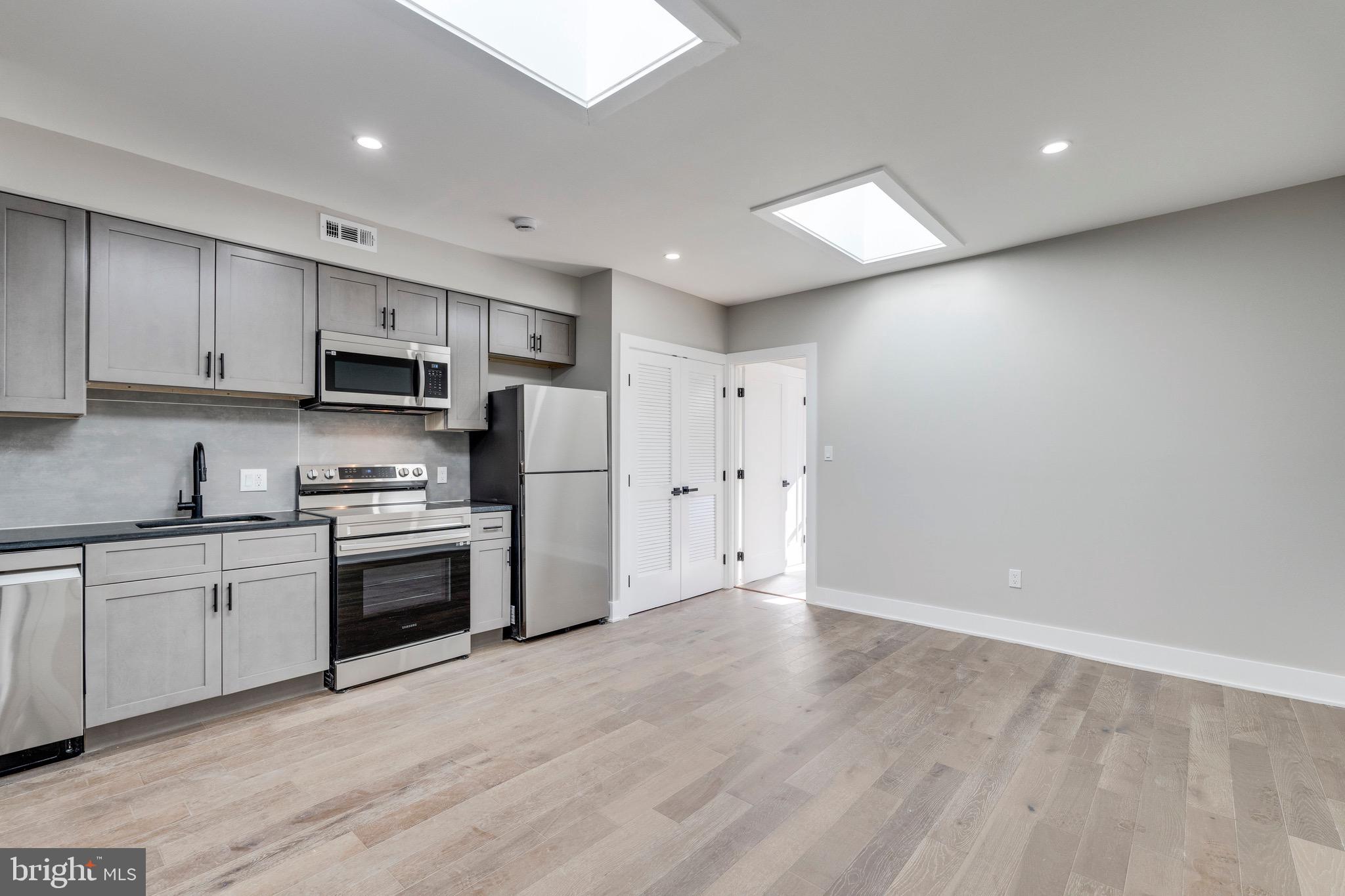 1703 West Virginia Avenue Northeast, Unit 2 Washington, DC 20002 - Photo 34 of 54 a kitchen with stainless steel appliances granite countertop a stove a sink and a refrigerator