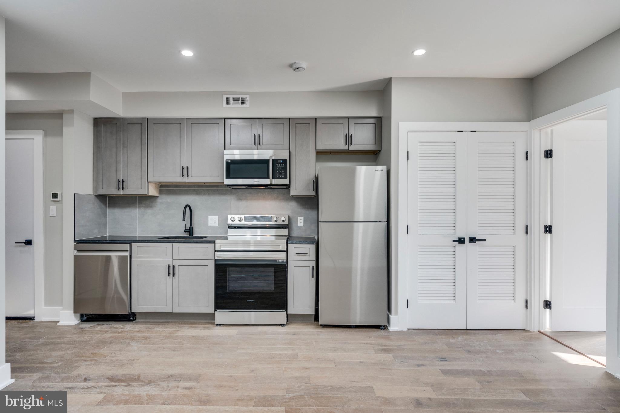 1703 West Virginia Avenue Northeast, Unit 2 Washington, DC 20002 - Photo 35 of 54 a kitchen with cabinets stainless steel appliances and a counter space