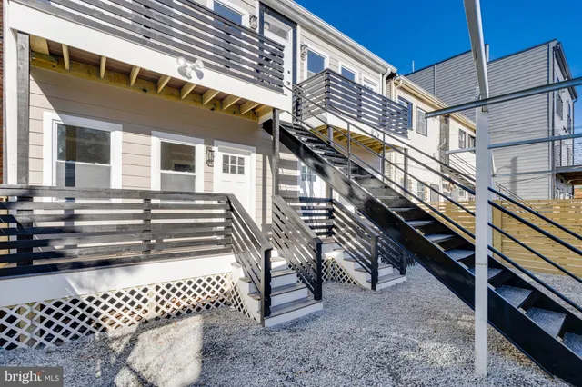 a view of a house with a wooden deck