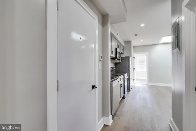 a view of hallway with wooden floor