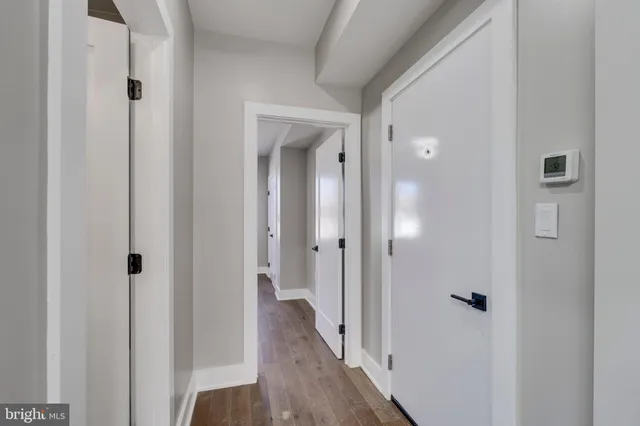 a view of a hallway with wooden floor