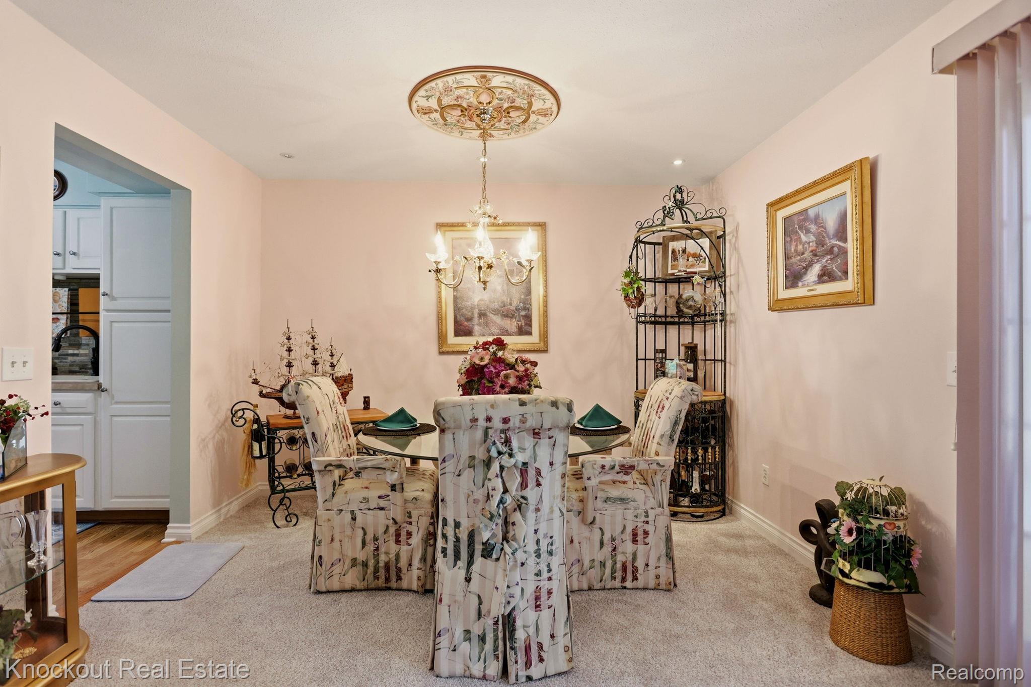 249 Churchgrove Road Frankenmuth, MI 48734 - Photo 12 of 44 Dining area featuring a decorative ceiling medallion with an attached chandelier, soft wall tones, and carpet flooring