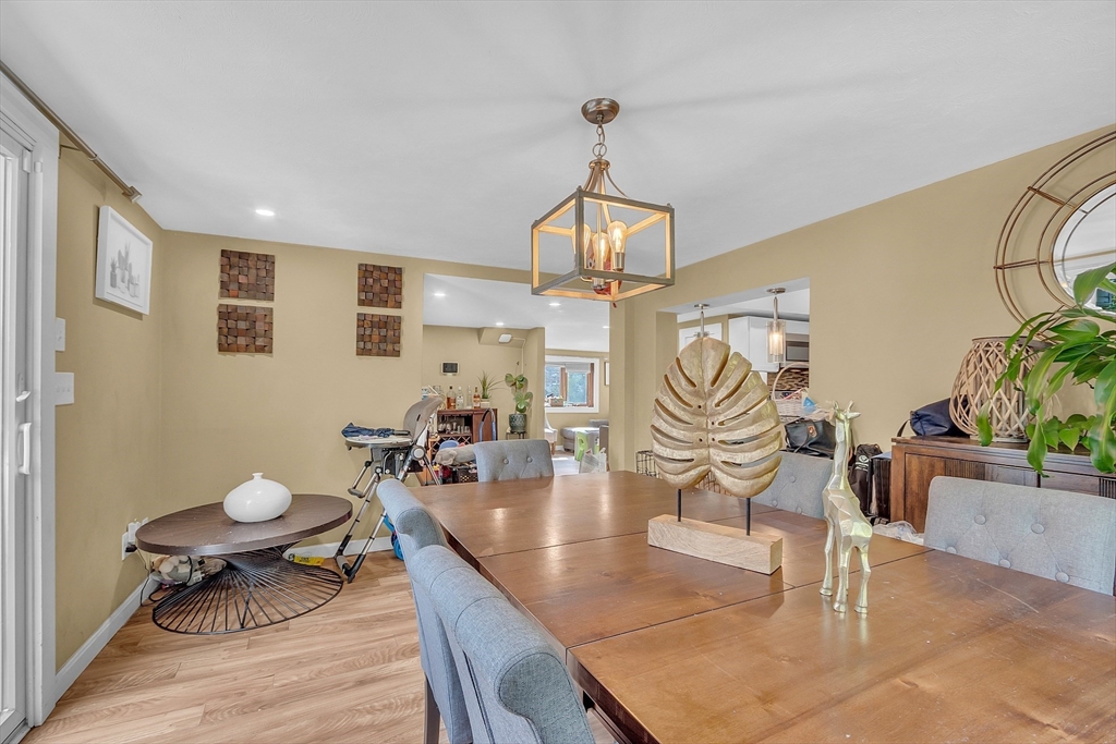 296 Howe Street Methuen, MA 01844 - Photo 6 of 12 a living room with furniture a dining table and a chandelier