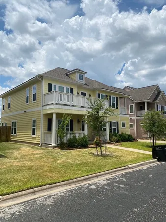 a front view of building with yard and green space