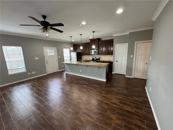 a view of a kitchen with a sink and a refrigerator