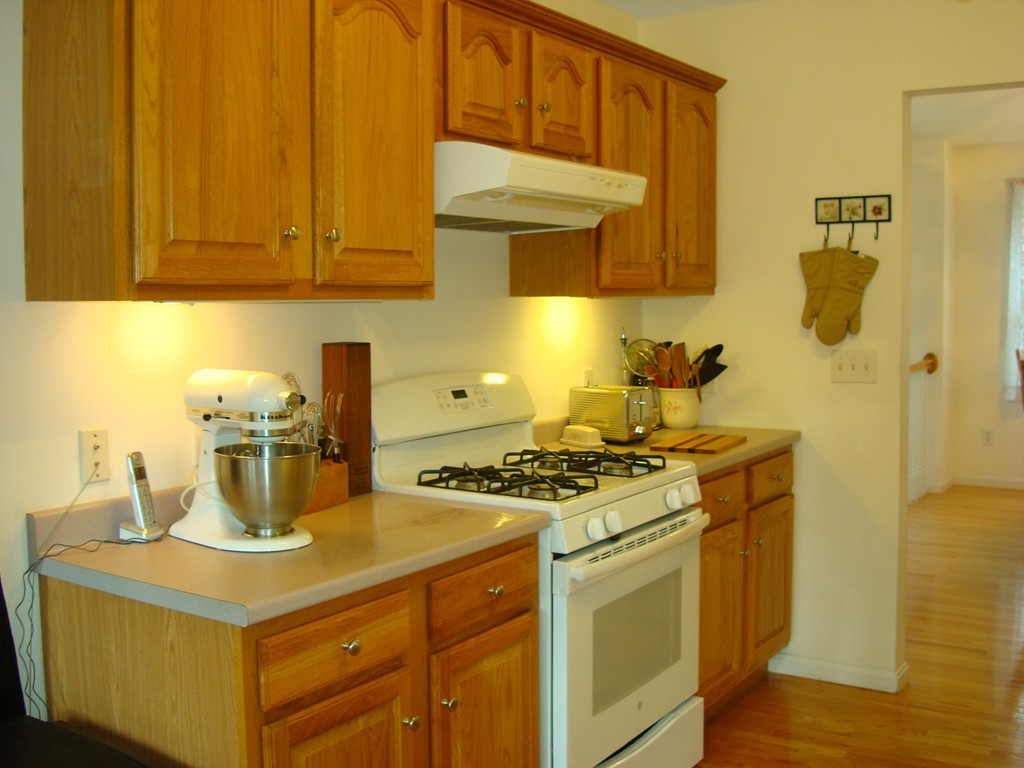 18 Rebecca Road Freetown, MA 02702 - Photo 14 of 30 a kitchen with a stove and a white cabinet