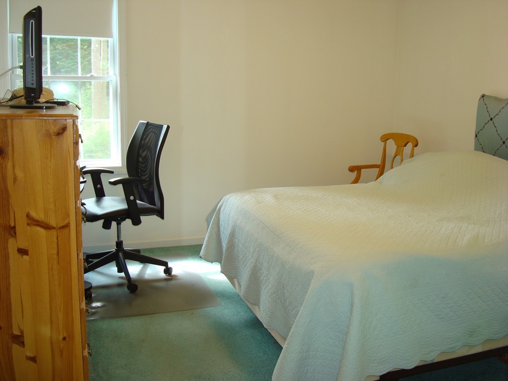 18 Rebecca Road Freetown, MA 02702 - Photo 24 of 30 a bedroom with a bed and a chair