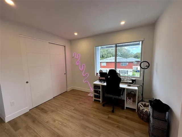 a view of a workspace with furniture and a window