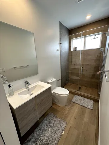 a bathroom with a sink mirror toilet and shower