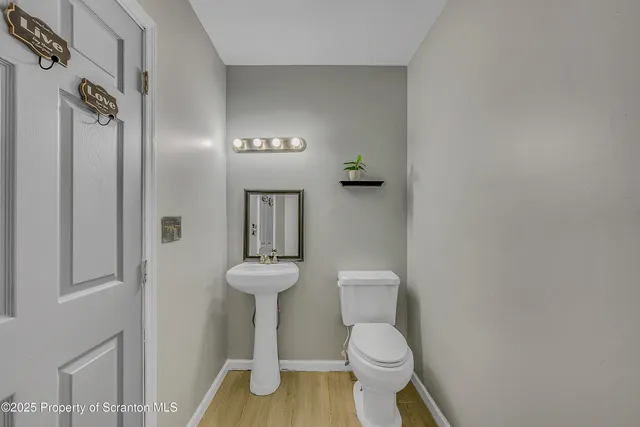 a white toilet sitting next to a bathroom sink