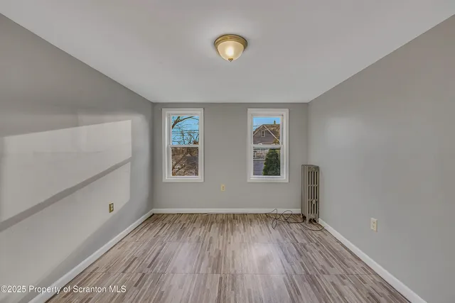 a view of room with window and hardwood floor